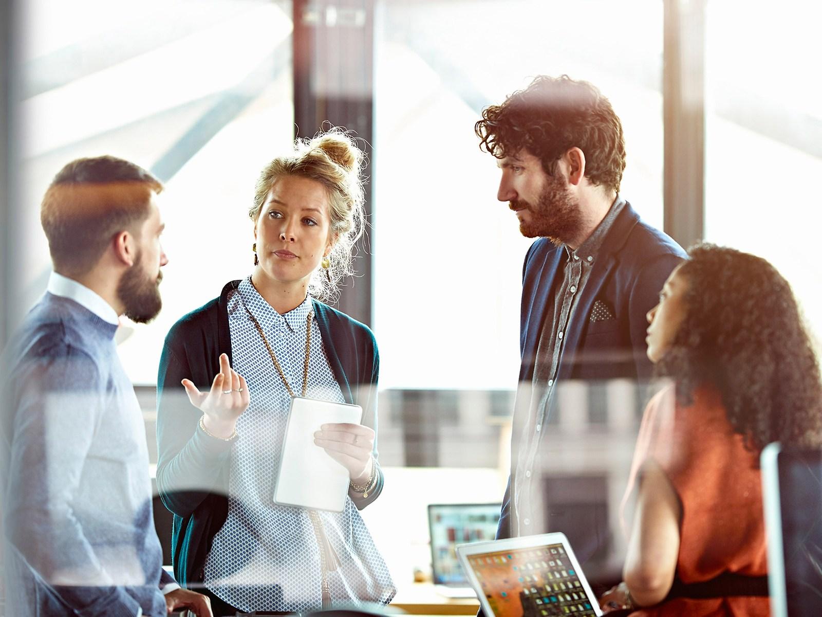 Four people talking in a room